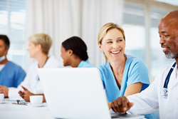 Image of health care workers at a computer.